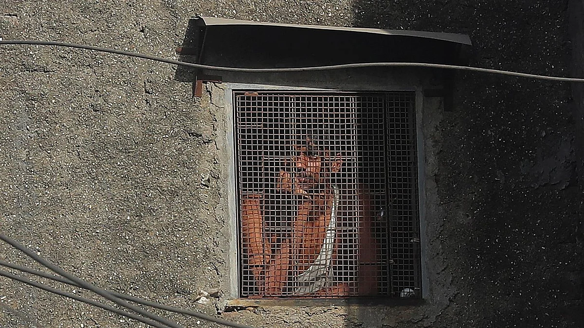 A migrant worker from another state looks through the window of his room in Dharavi, one of Asia’s largest slums, during lockdown to prevent the spread of the new coronavirus.