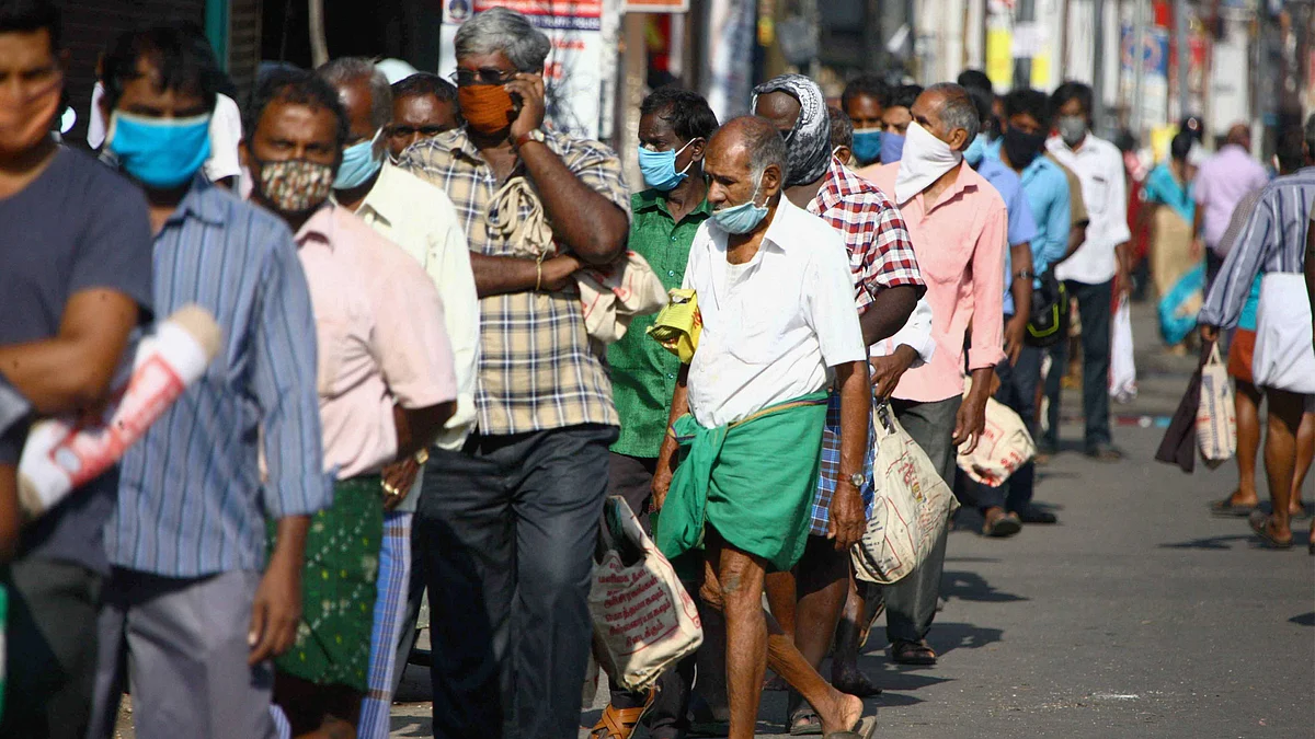 People stand in a queue to buy groceries and vegetables, during the lockdown, in Coimbatore, Thursday.