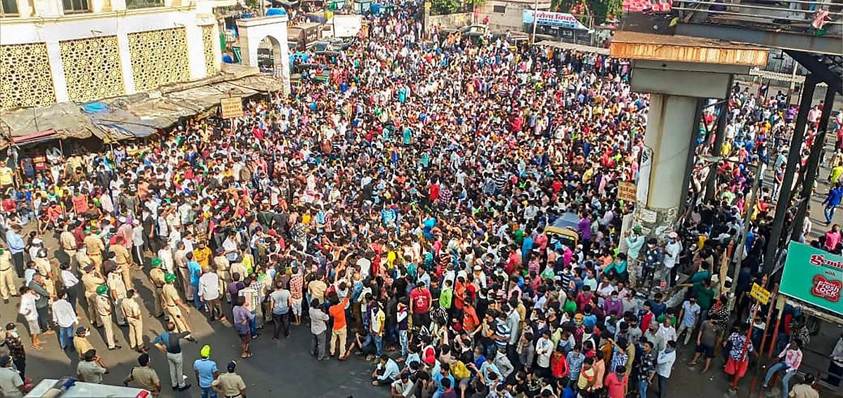 Migrant workers gather outside Bandra West Railway Station.