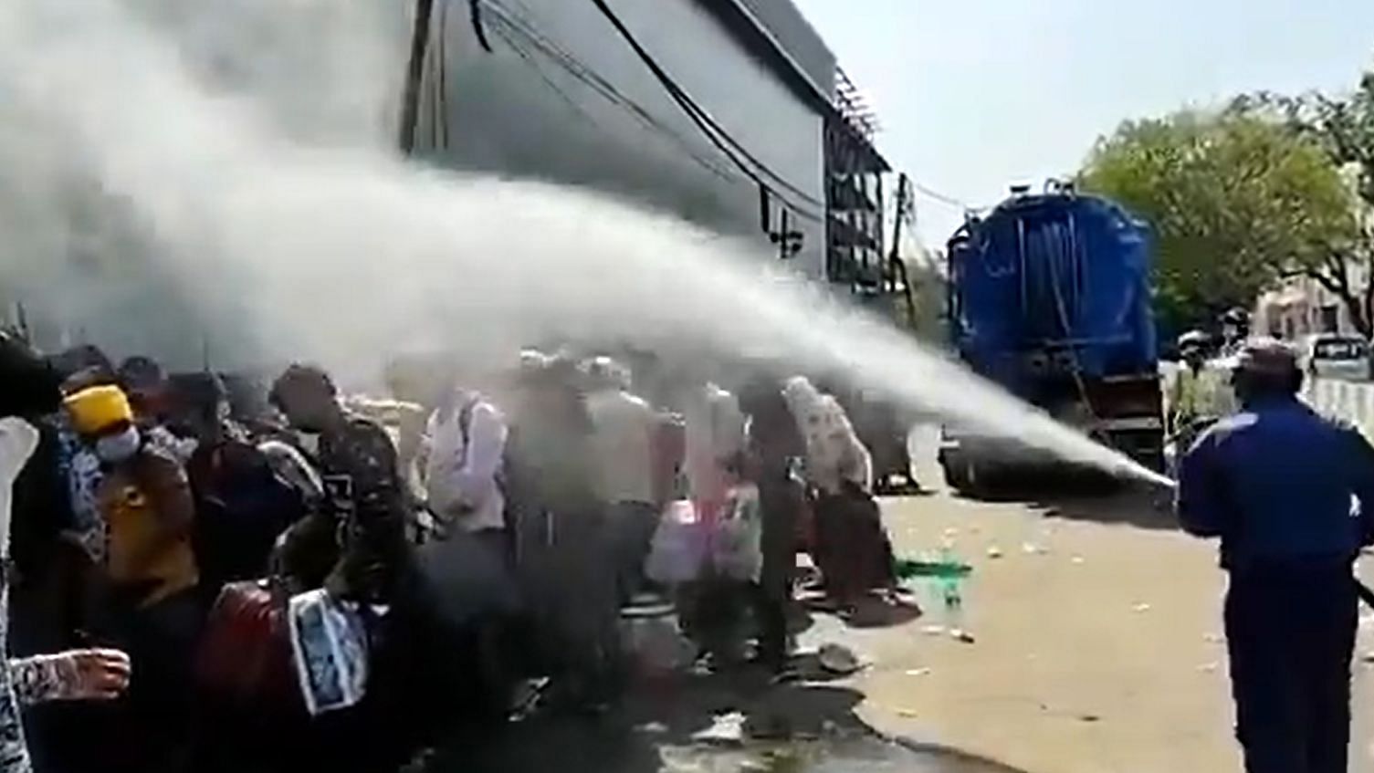 Migrants are being sprayed with disinfectant in Delhi. 