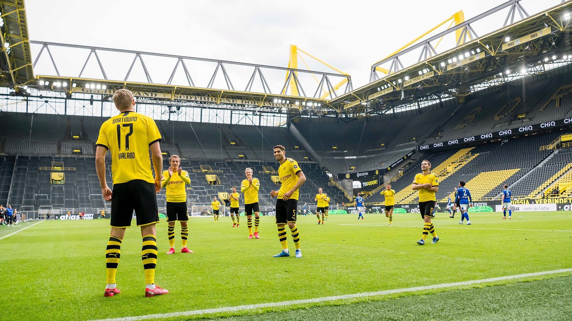 Borussia Dortmund players celebrate a goal on the first day of Bundesliga’s return.