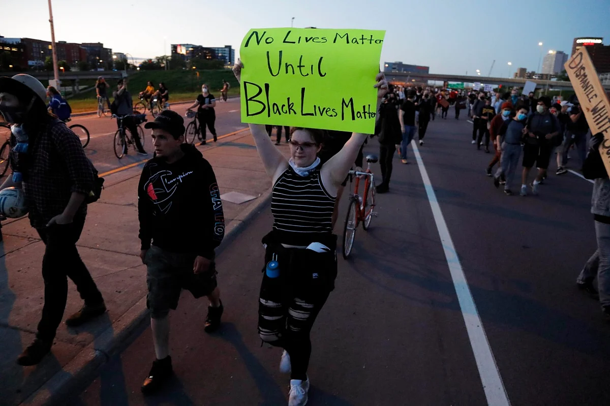 Protesters move along a highway Friday, 29 May, in Minneapolis. Protests continued following the death of George Floyd who died after being restrained by Minneapolis police officers on Memorial Day.