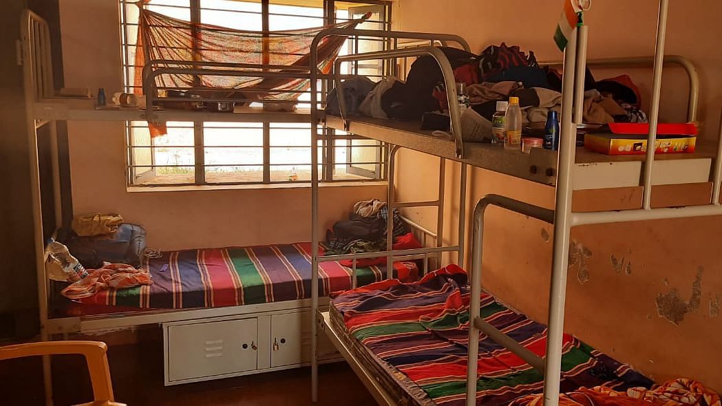 Days after reaching Bengaluru by train on 14 May, none of the passengers staying in a government facility have been tested using RT-PCR for COVID-19. 3-5 people have been accommodated in each room with beds attached.