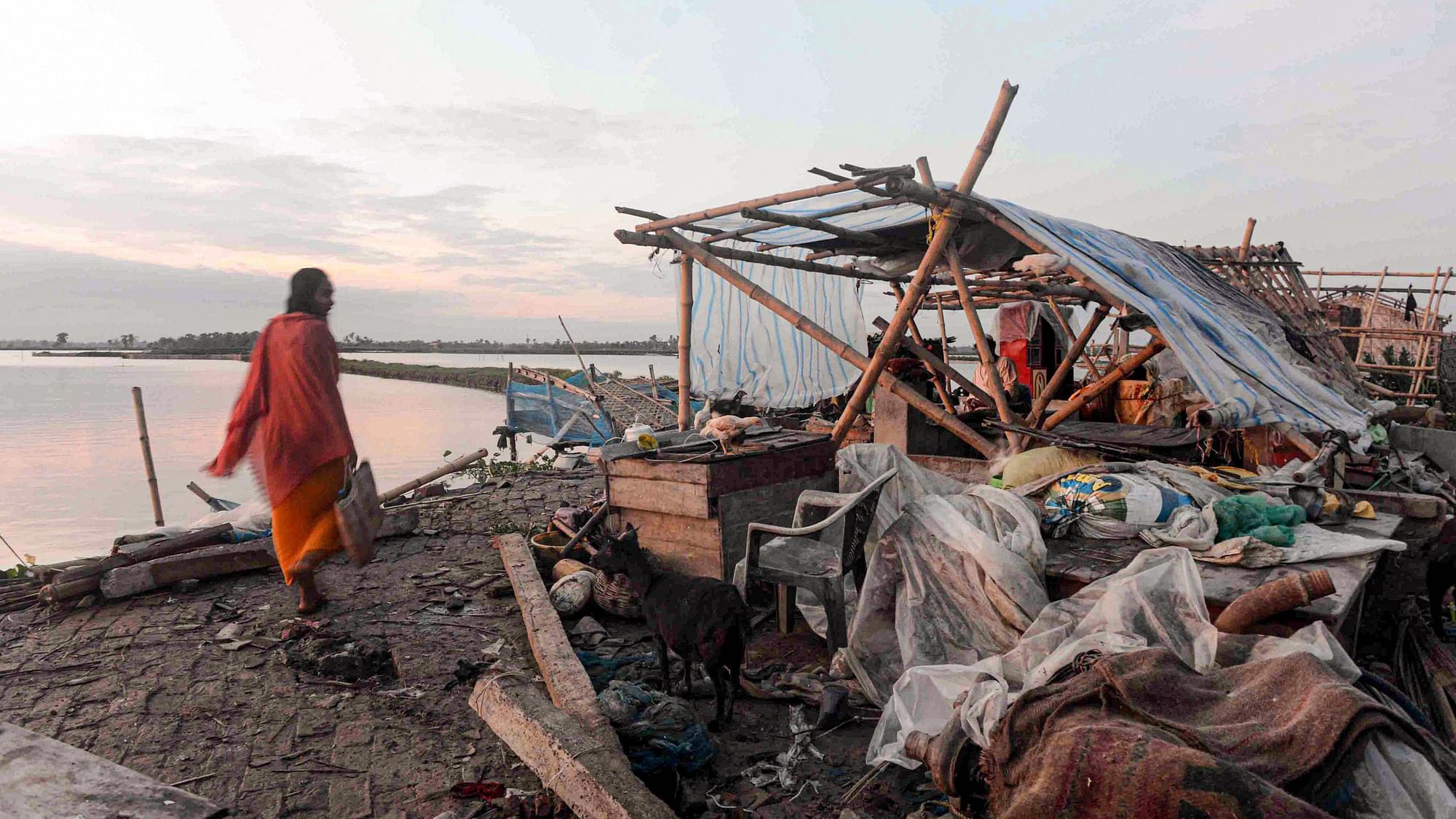 A villager walks past a damaged house, in the aftermath of Cyclone Amphan, in South 24 Paraganas district of West Bengal, Friday, May 22, 2020.