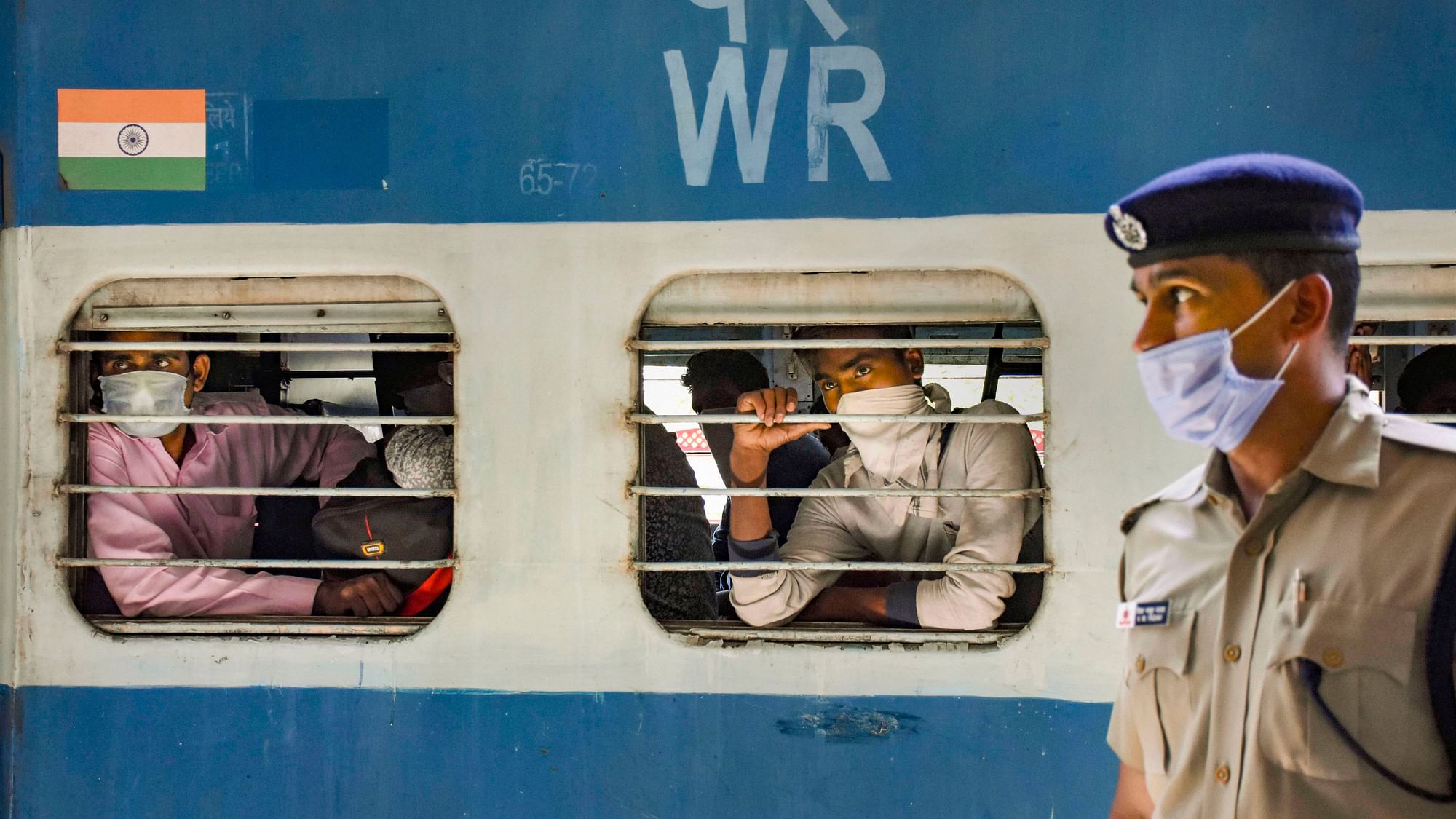 Migrants arrive at a railway station via special trains arranged for them from Ahamdabad, during the ongoing COVID-19 nationwide lockdown, in Amethi, Thursday, 7 May 2020.