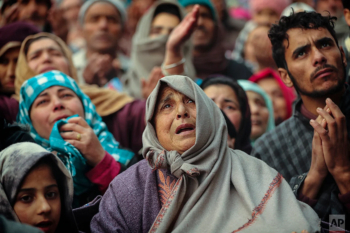 Kashmiri Muslim devotees offer prayer outside the shrine of Sufi saint Sheikh Syed Abdul Qadir Jeelani in Srinagar.