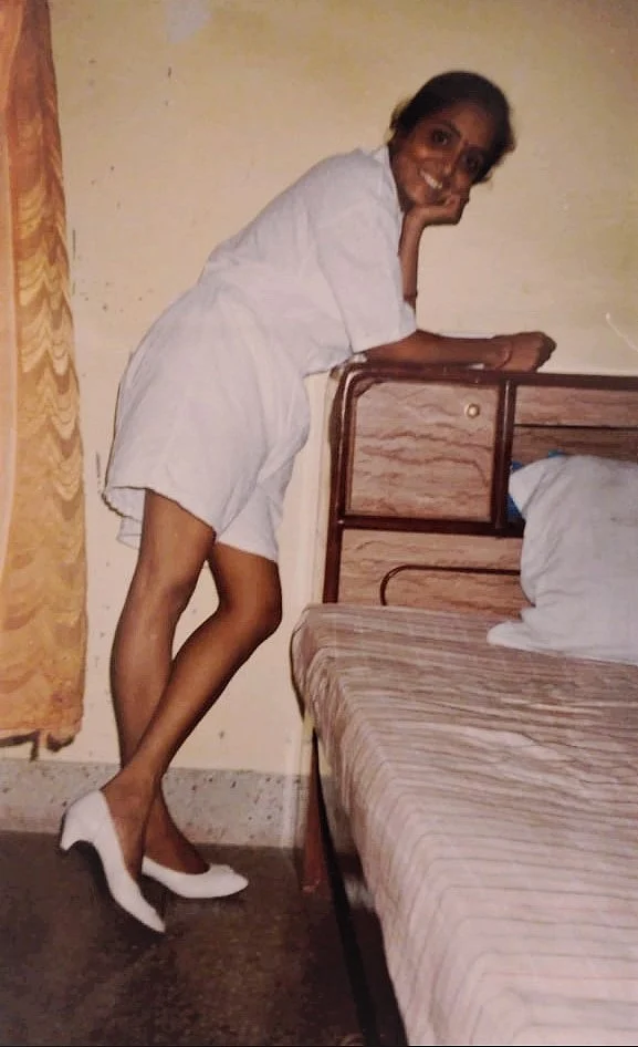 A picture of my mother smiling for the camera.