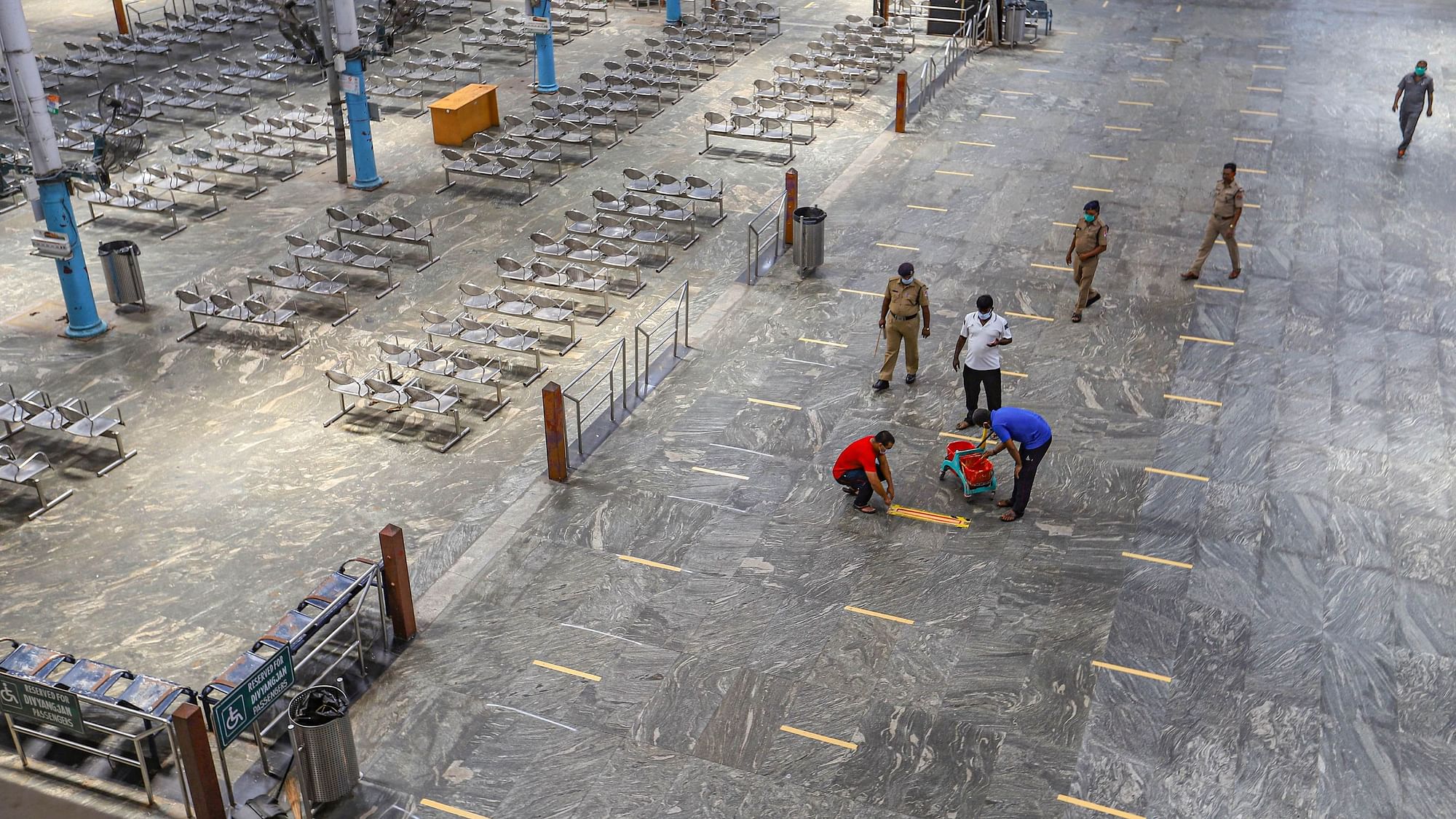 Chennai: Railway Protection Force (RPF) personnel draw social distancing mark on a floor at Dr MG Ramachandran Central Railway station during a government-imposed nationwide lockdown.
