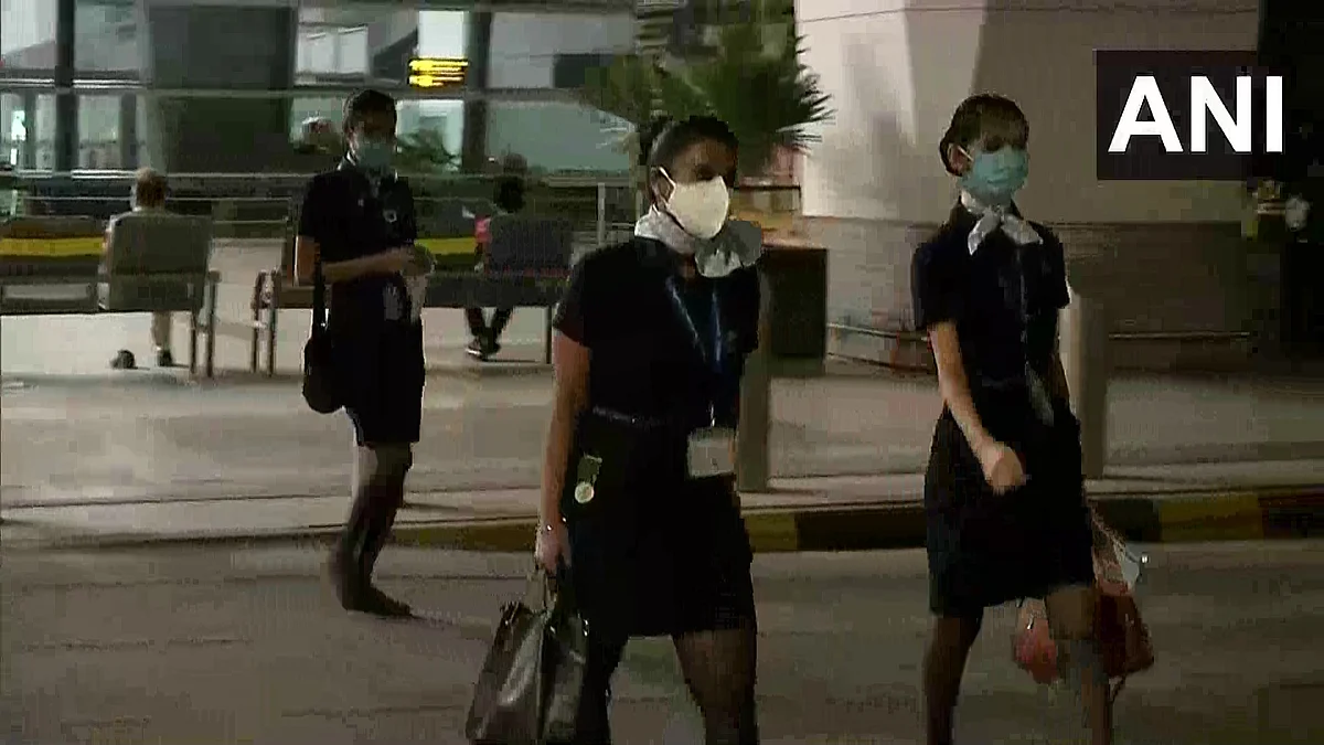 Indigo cabin crew arriving at the Delhi airport for an early morning flight.