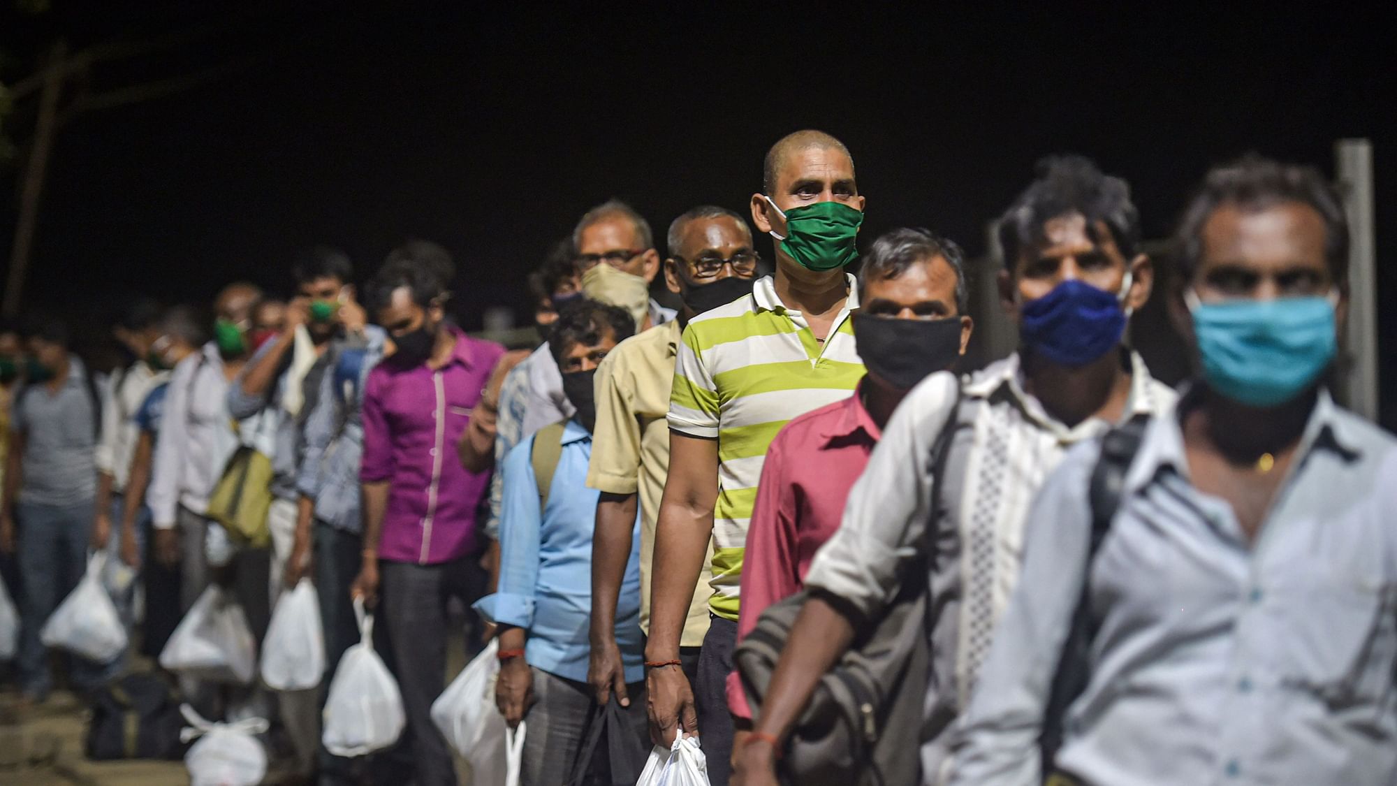  Migrants from various northern states of India wait to board a special train for Gorakhpur, during the ongoing COVID-19 lockdown, in Bhiwandi, Saturday, May 2, 2020.