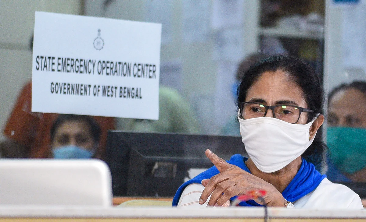 West Bengal CM Mamata Banerjee, wearing a mask, monitors the movement of cyclone Amphan from the control room ahead of its landfall, Tuesday.