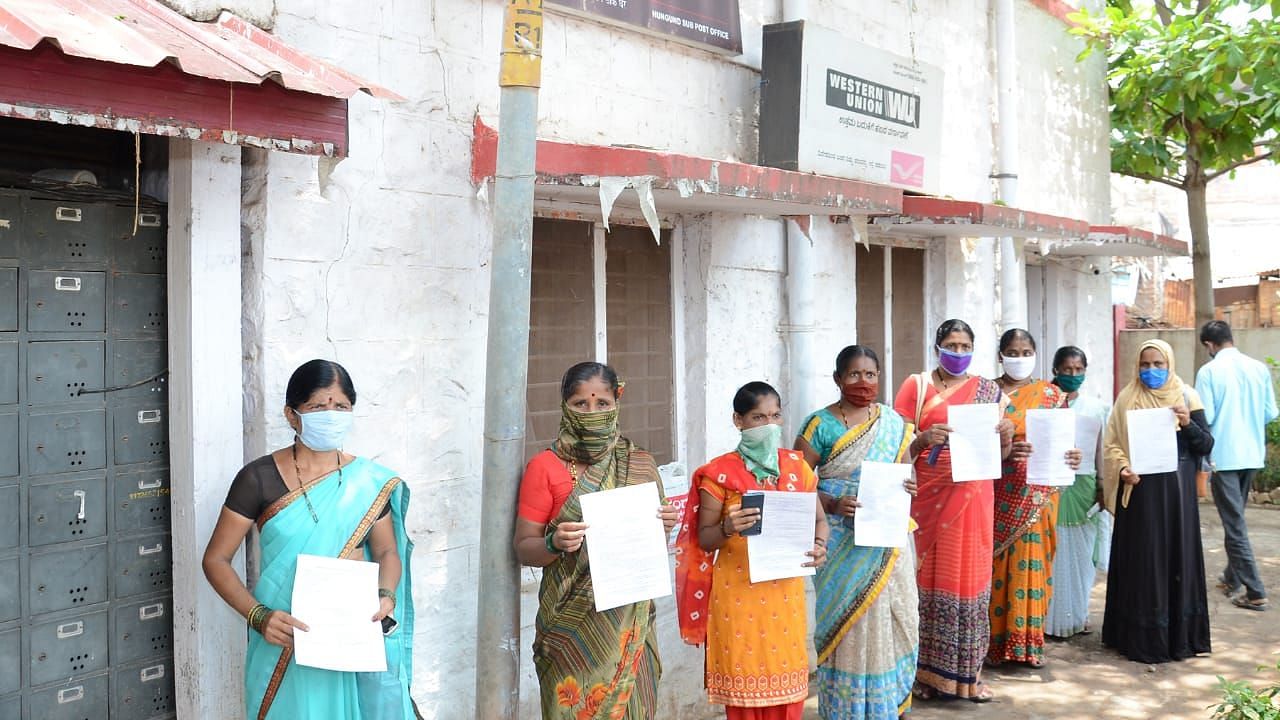 Aggrieved women line up outside a post office in Karnataka’s Bidar to send money orders to CM BS Yediyurappa over restarting the sale of liquor in the third phase of the lockdown.