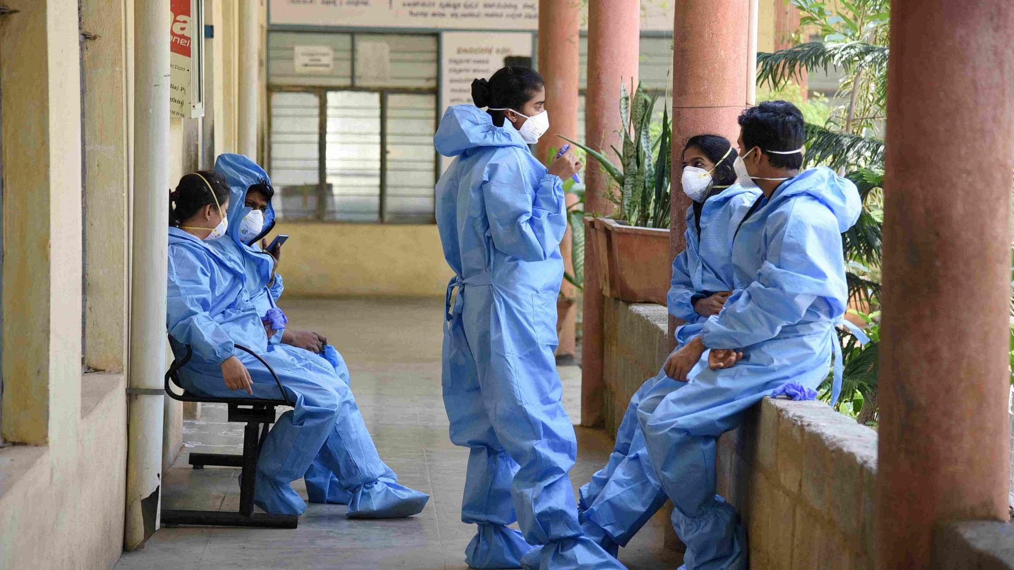 Coronavirus News Live Updates: Medics wearing protective suits are seen at a hospital in Bengaluru.