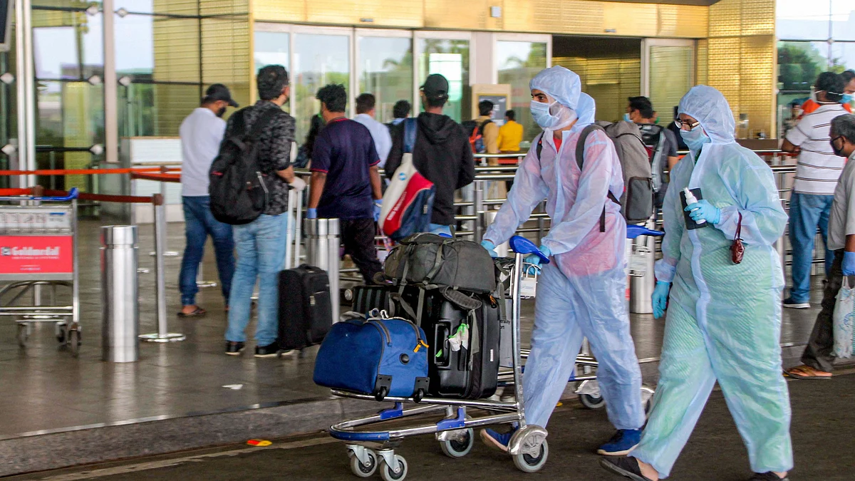 Passengers arrive to take a flight at Shivaji Maharaj International Airport, during the ongoing COVID-19 nationwide lockdown, in Mumbai, Monday, 25 May.