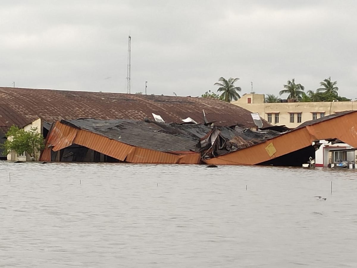 Flooded runway, a collapsed hangar and an airplane damaged under a caved-in roof, show the impact of the cyclone.