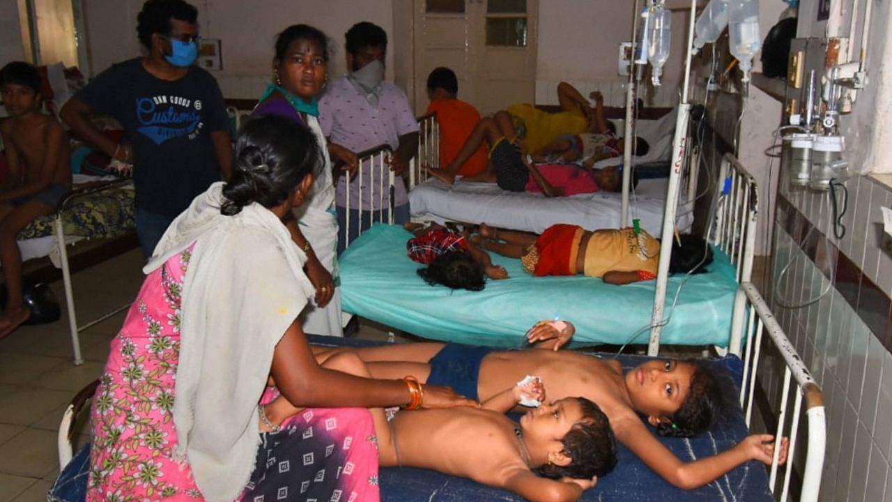 Family members take their unconscious children to a hospital after a major chemical gas leakage at LG Polymers industry in RR Venkatapuram village.