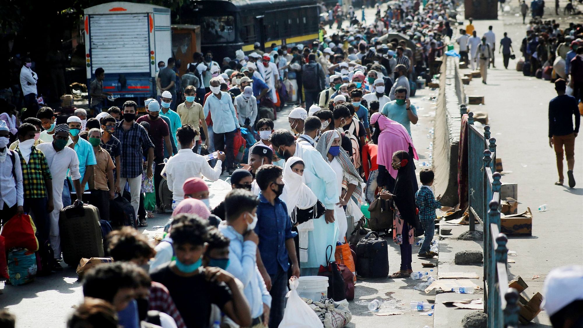 Migrants queue up in Mumbai as they wait endlessly for transport to take them to the railway station.