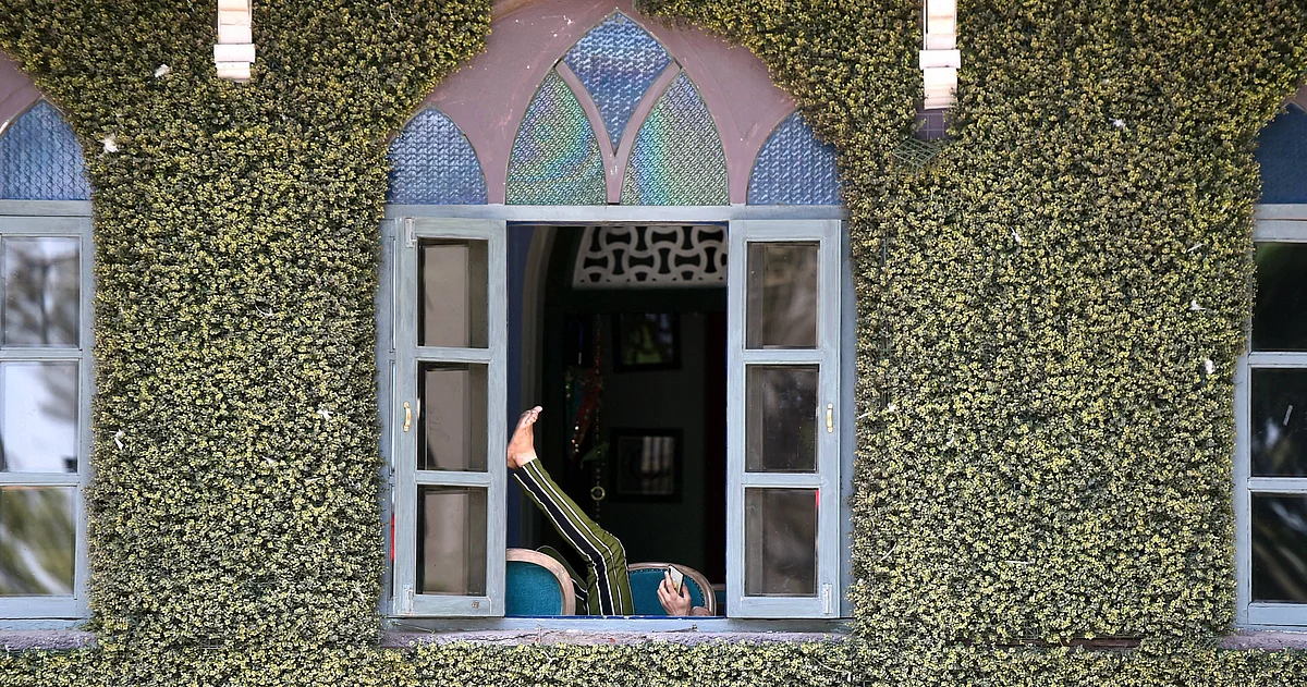 A man rests in a closed restaurant, during the ongoing lockdown, at Sassoon Dock in Mumbai, Tuesday.