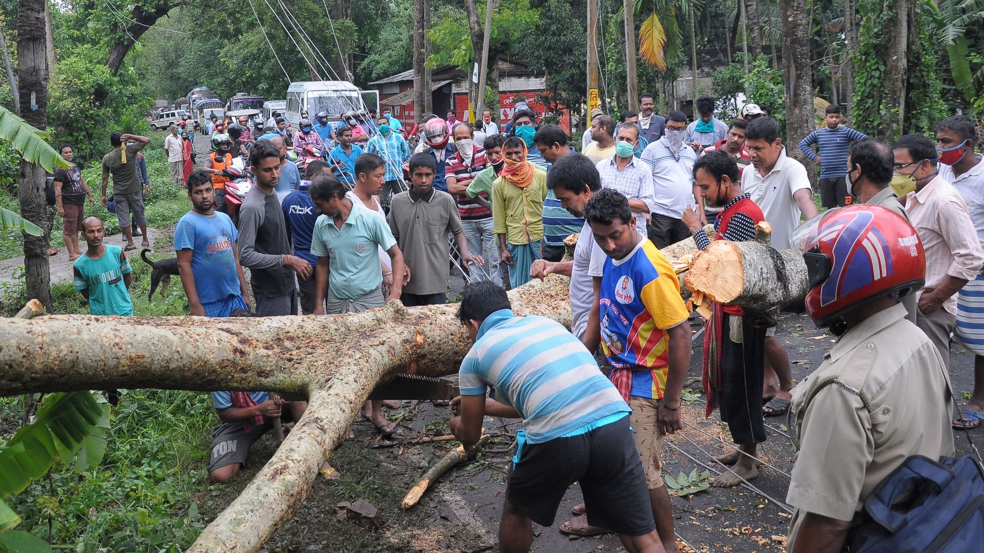 Locals trying to clear the road after cyclone Amphan wreaked havoc in West Bengal on Wednesday, 20 May.