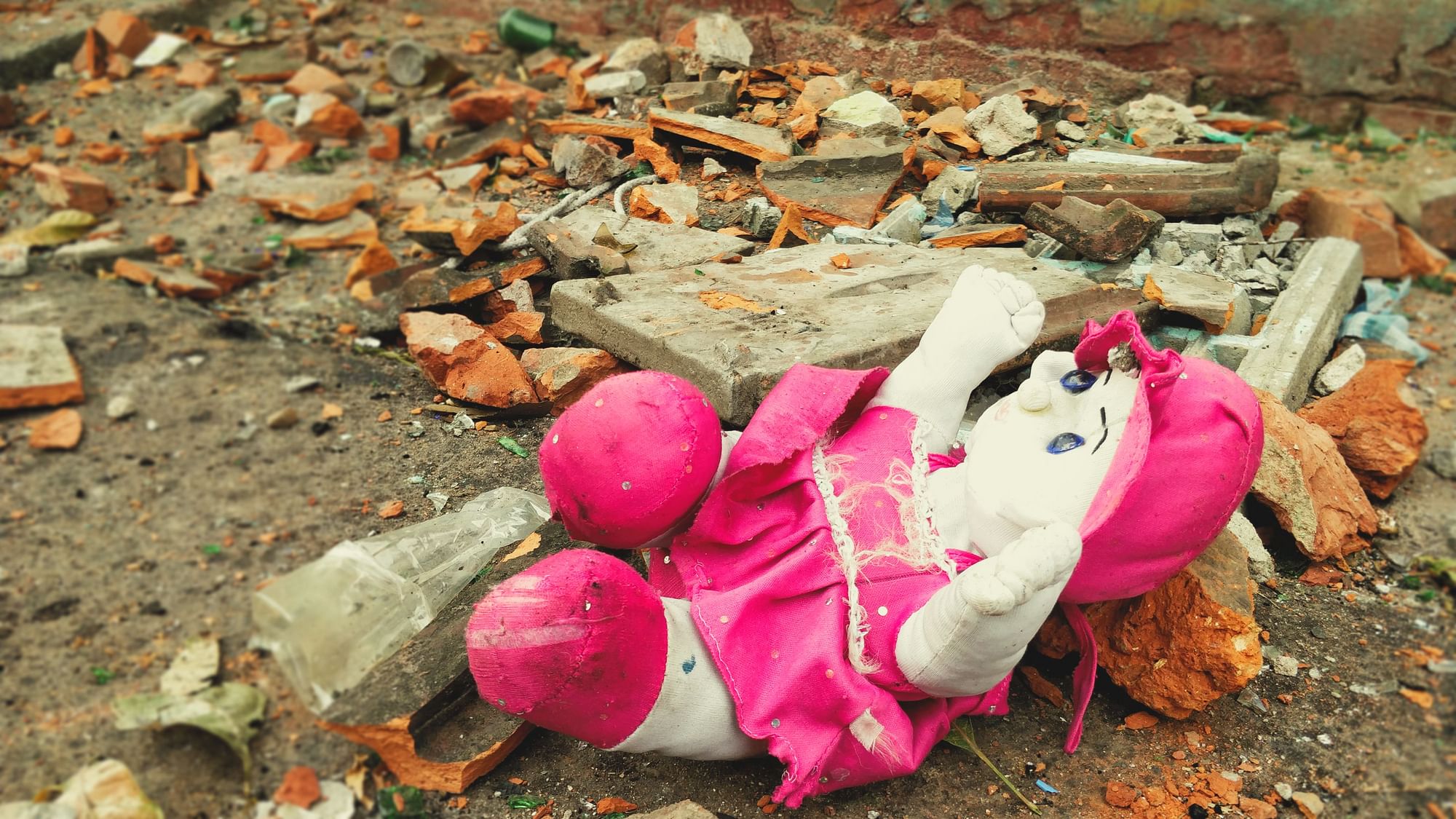 A forgotten doll lies amidst broken bricks and shards of glass at the site of violence in at a locality called Telinipara in West Bengal's Hooghly district.