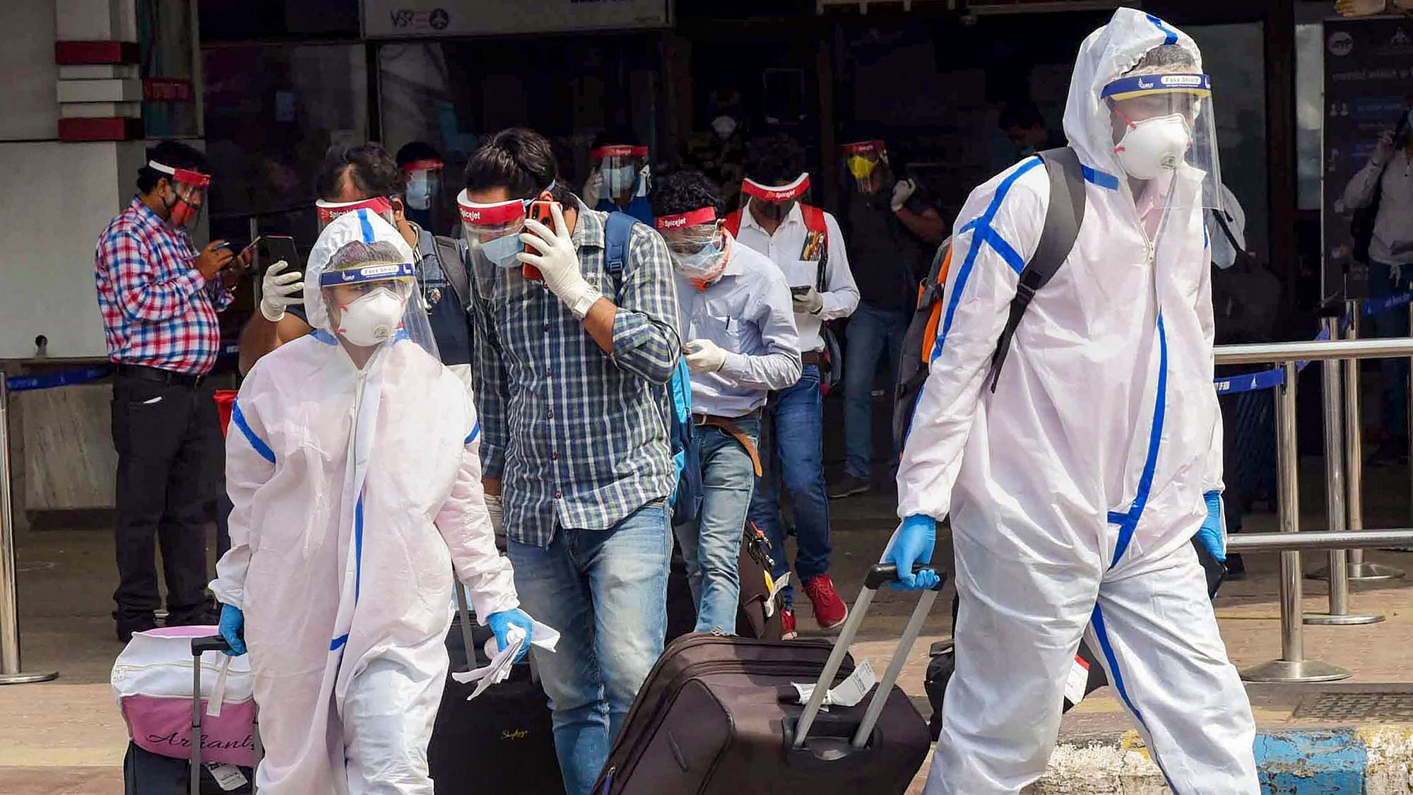 Passengers wearing PPE kits check-out from the Jai Prakash Narayan International Airport, Patna upon their arrival from Bengaluru during the ongoing COVID-19 lockdown on Thursday, 28 May 28. 