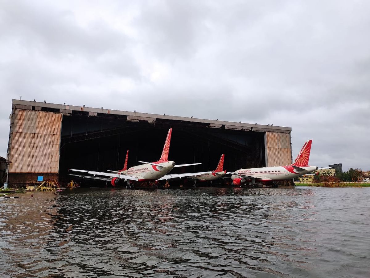 Flooded runway, a collapsed hangar and an airplane damaged under a caved-in roof, show the impact of the cyclone.