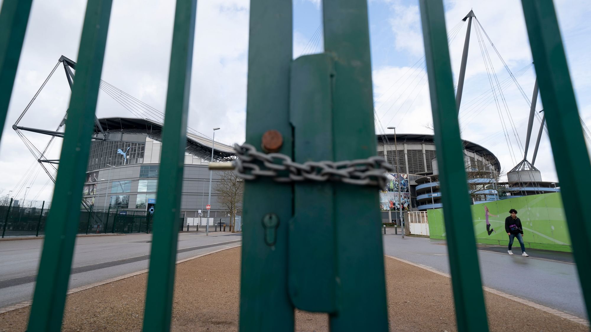 A locked gate is seen by the Etihad Stadium where Manchester City was due to play Burnley in an English Premier League match Saturday March 14, 2020.