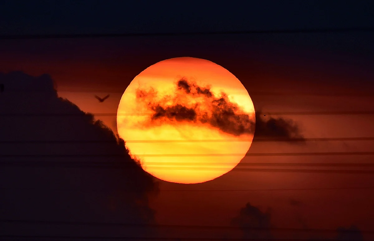 A view of sunrise over the sky near Pallikaranai, during the nationwide lockdown in Chennai, Friday.
