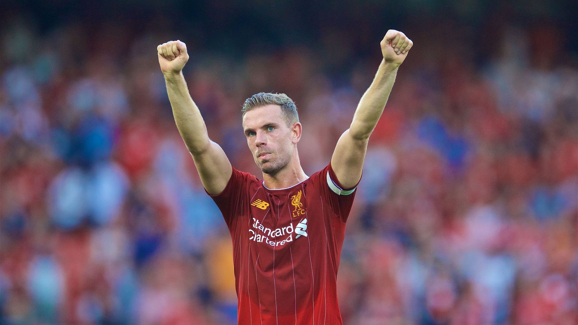 Liverpool’s captain Jordan Henderson celebrates a team goal.