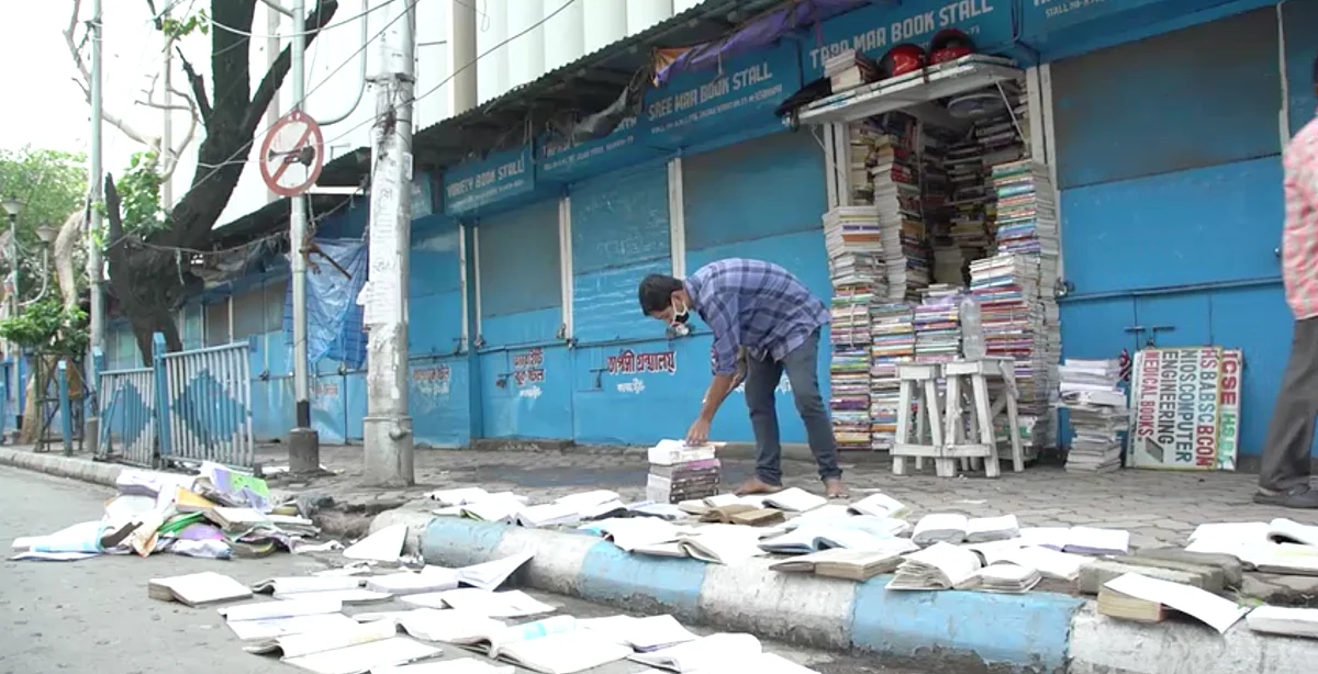 A bookseller in college streetm, trying to dry damp books.