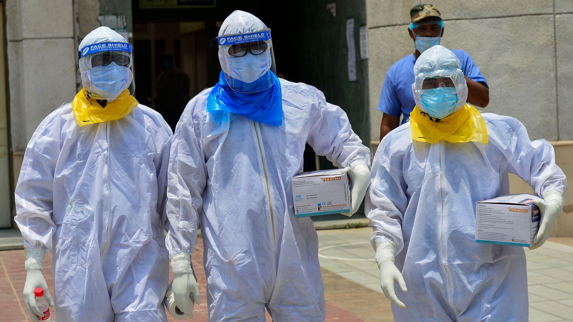 Medics arrive to take samples of suspected COVID-19 patients for lab tests at a government hospital in New Delhi.