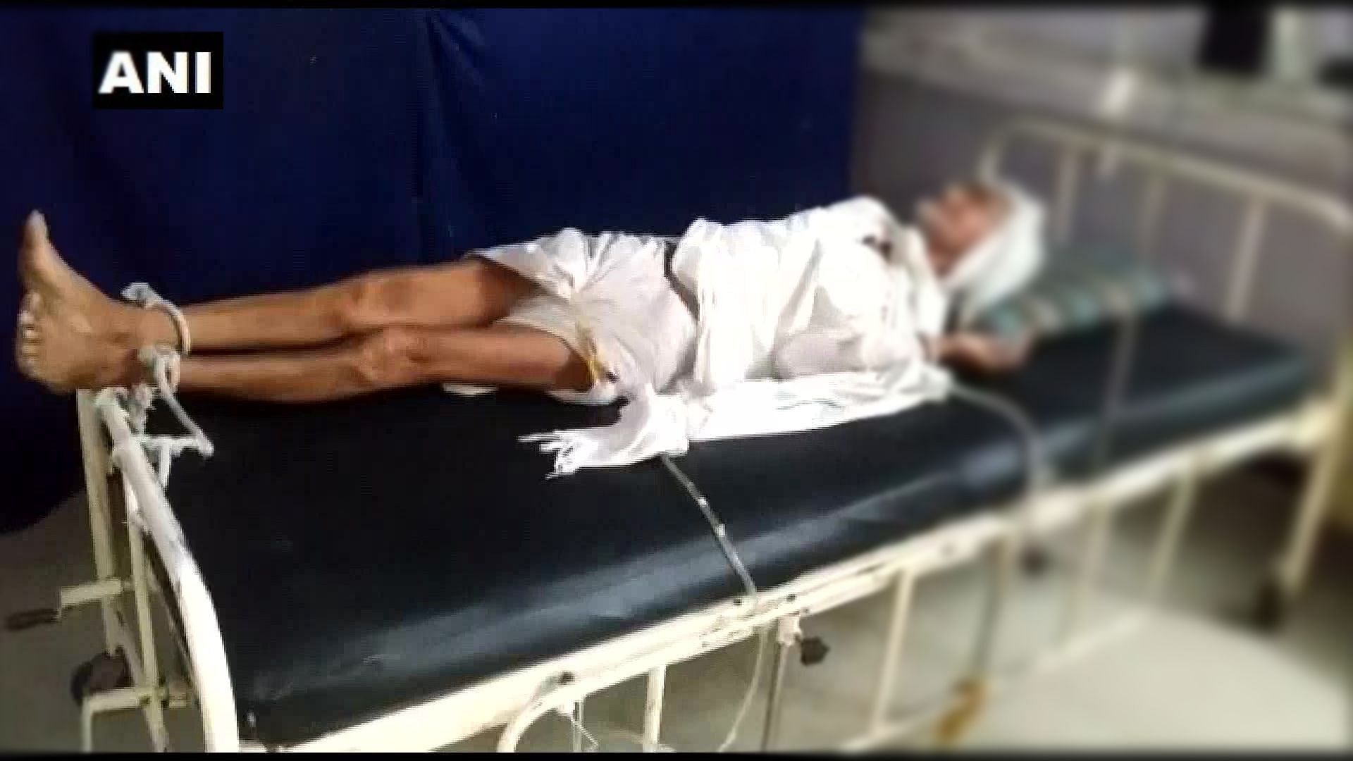 An old man is seen tied to a hospital bed in Madhya Pradesh. His family claimed that they failed to pay the hospital.