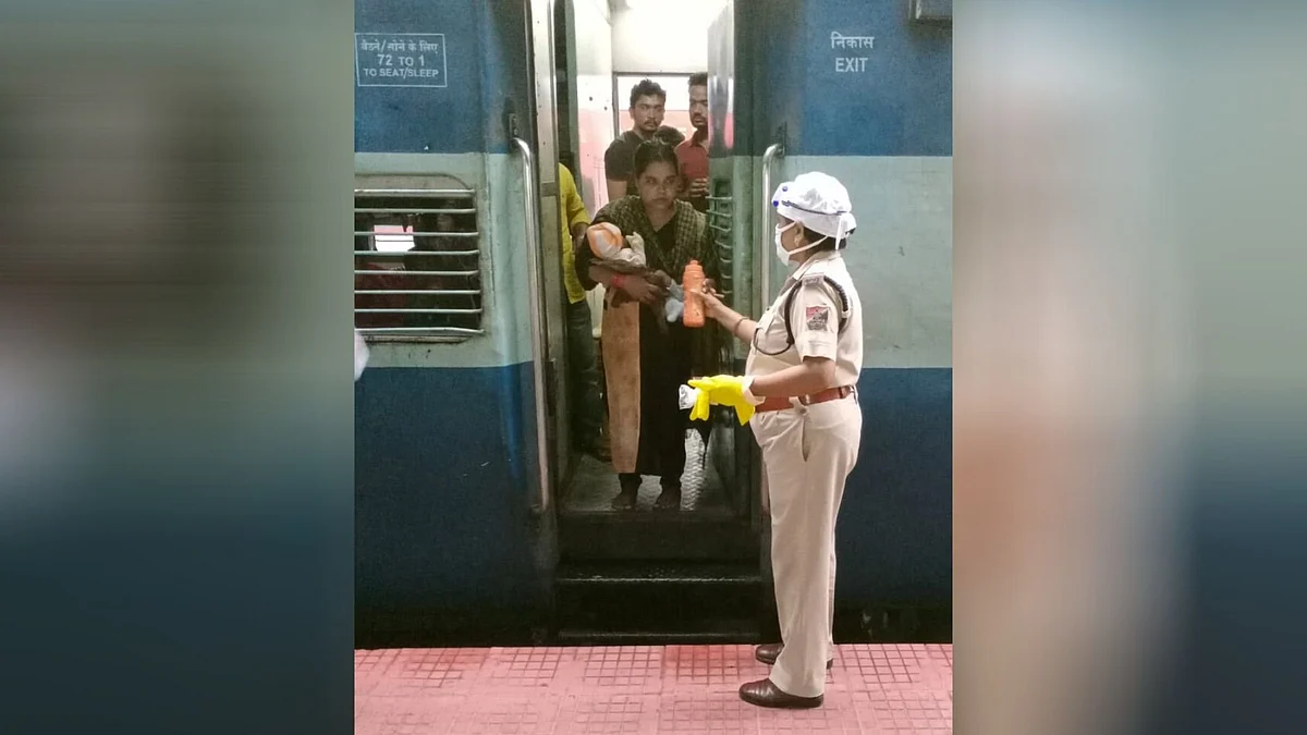 A cop helps out a female passenger with a baby.