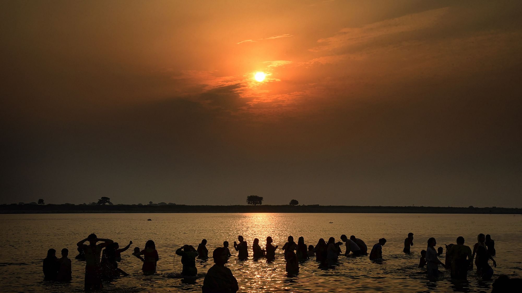 Devotees pray and take bath in the Ganga River on the occasion of Ganga Dussehra, in Patna, on Monday, 1 June 2020.