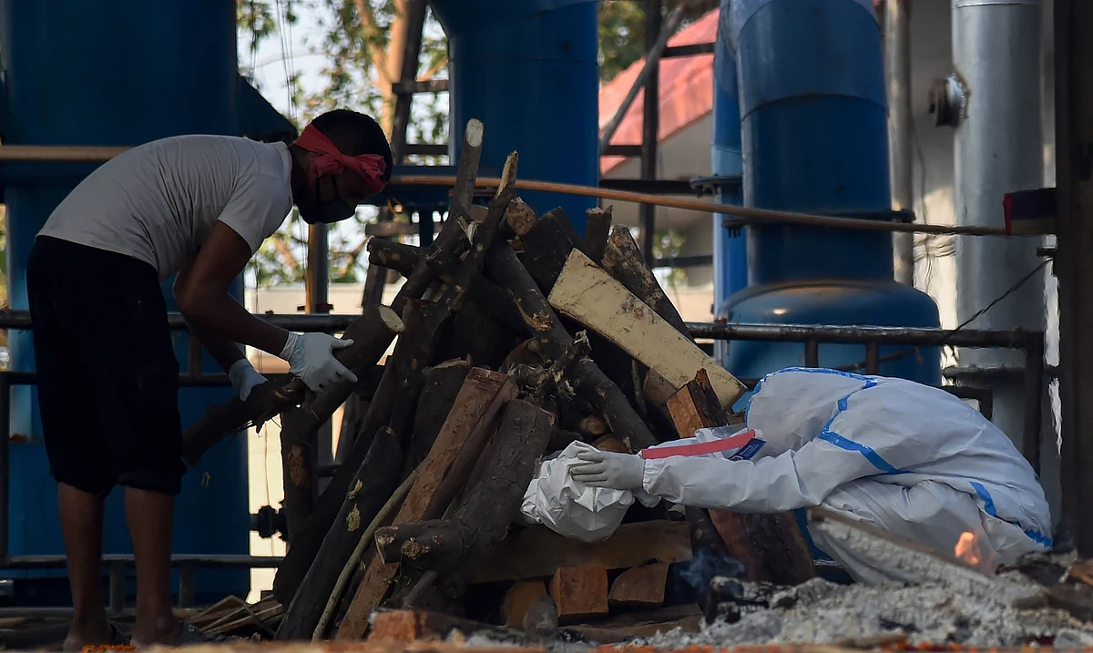 Son of SI Karambeer performs last rites of his father during his funeral ceremony, in New Delhi.