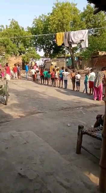 Residents stand in line for ration.
