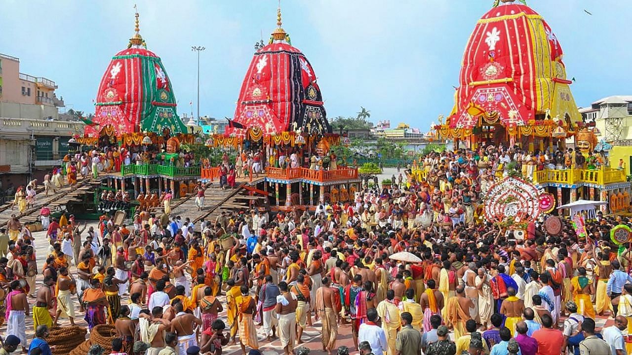 Priests and devotees take part in the pahandi rituals of Lord Jagannath Rath Yatra in Puri, on 23 June 2020.