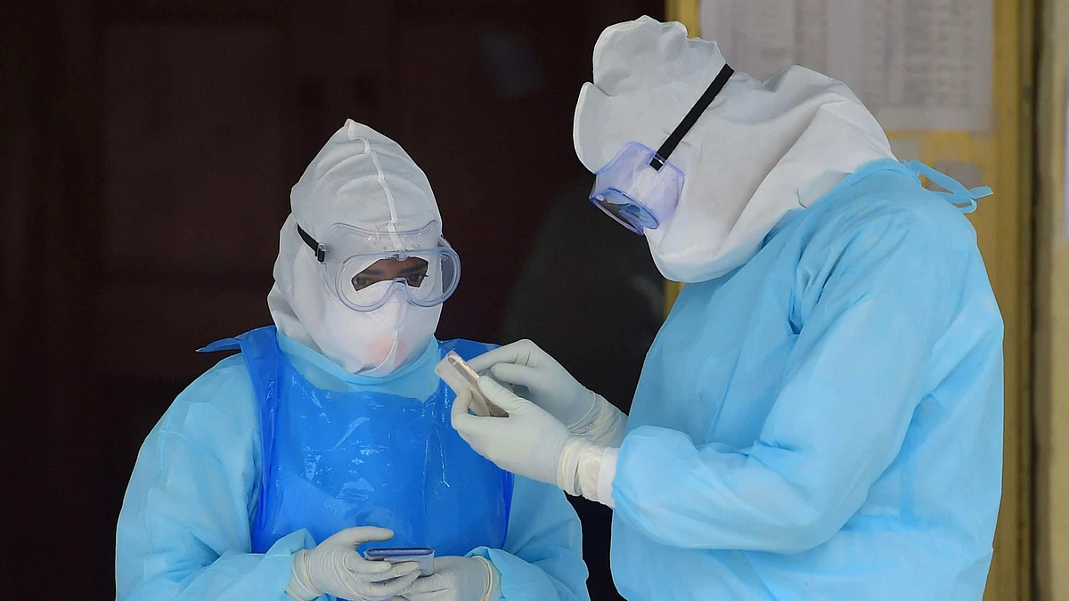 Medics wearing PPE suits stand outside the COVID-19 ward of Victoria Hospital in Bengaluru on 17 June. Image used for representational purposes.