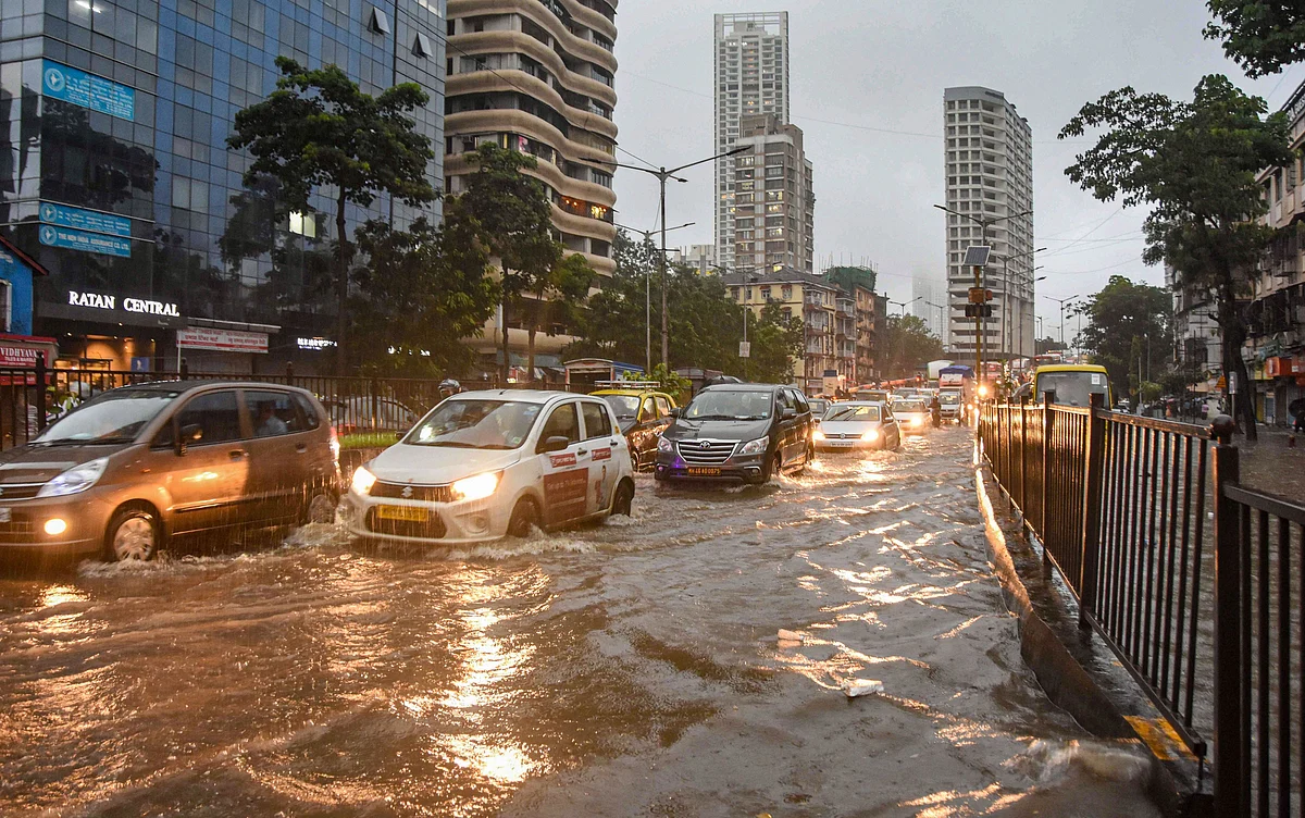 Vehicles ply on a water-logged street in Parel, Mumbai.