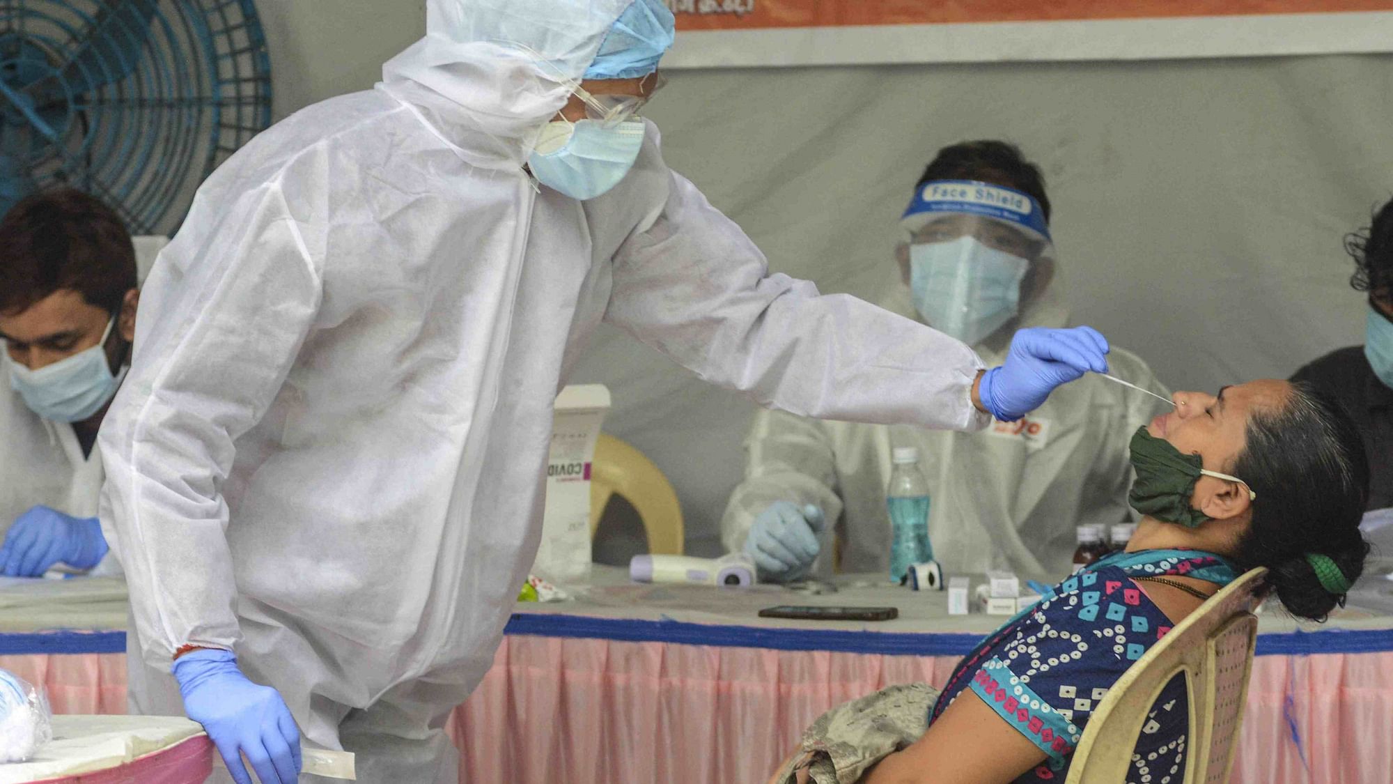 A medic collects a sample of a resident of Mamledarwadi for a COVID-19 test, at Malad in Mumbai on 16 July. Image used for representational purpose only. 