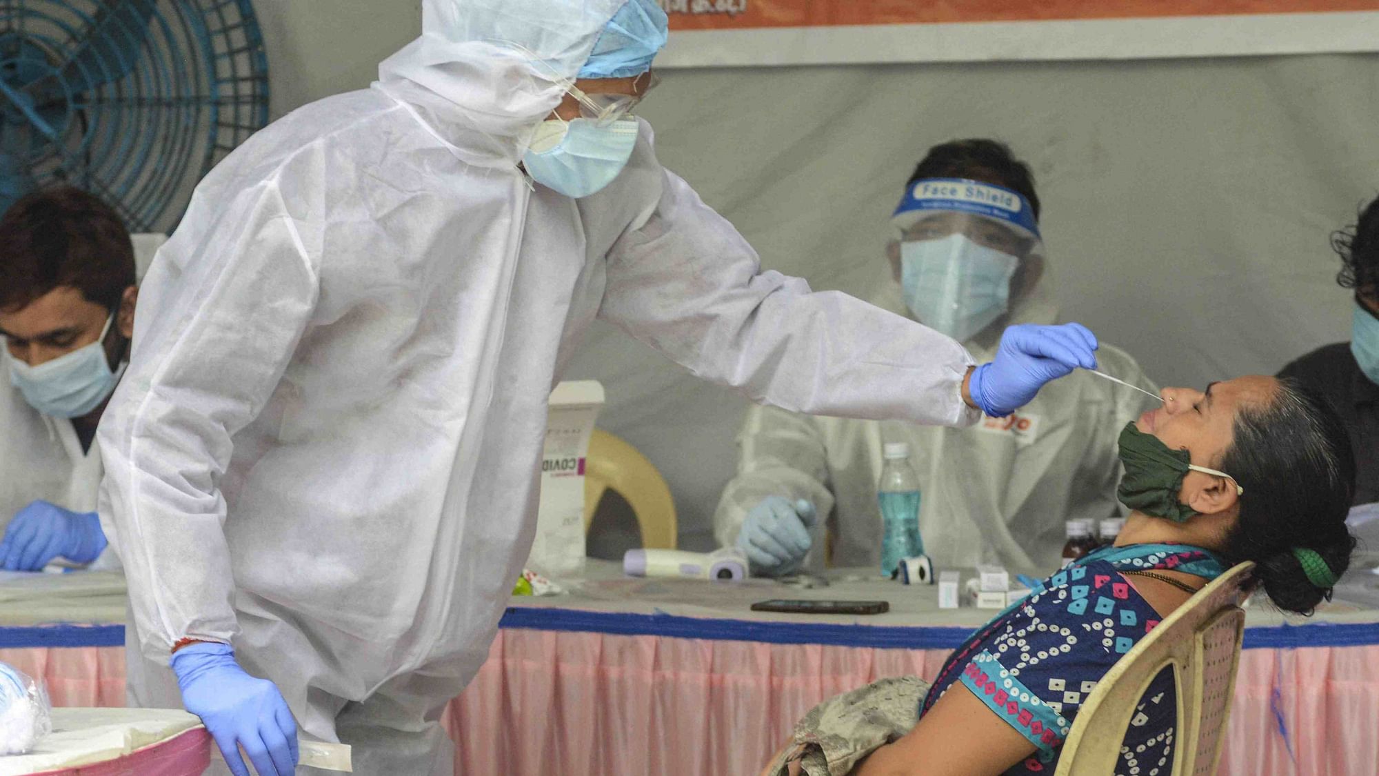 A medic collects a sample of a resident of Mamledarwadi for a COVID-19 test, at Malad in Mumbai. Image used for representational purpose only. 