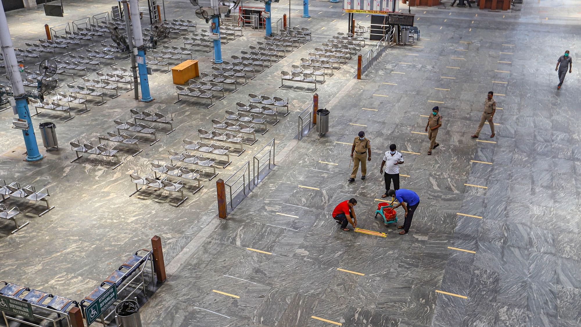 Chennai: Railway Protection Force  personnel draw social distancing mark on a floor at Dr MG Ramachandran Central Railway station during a government-imposed nationwide lockdown.&nbsp; Image used for representation.