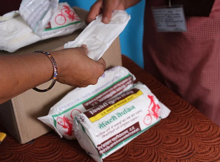 Before the lockdown: Nirasha Singh, principal of the Upper Primary School in Mawaiya village, Mirzapur district, distributing sanitary napkins to students.