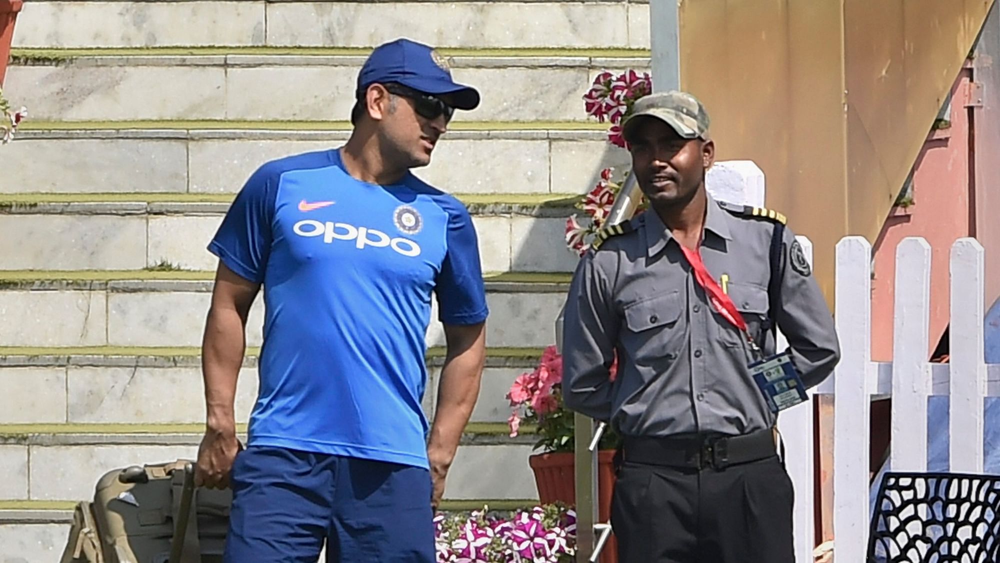 MS Dhoni interacts with a security guard during a training session ahead of the 3rd ODI match against Australia at JSCA Stadium, in Ranchi on 7 March, 2019.