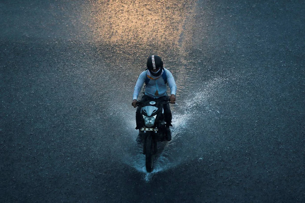 A man rides through the rains in Delhi, 2020.
