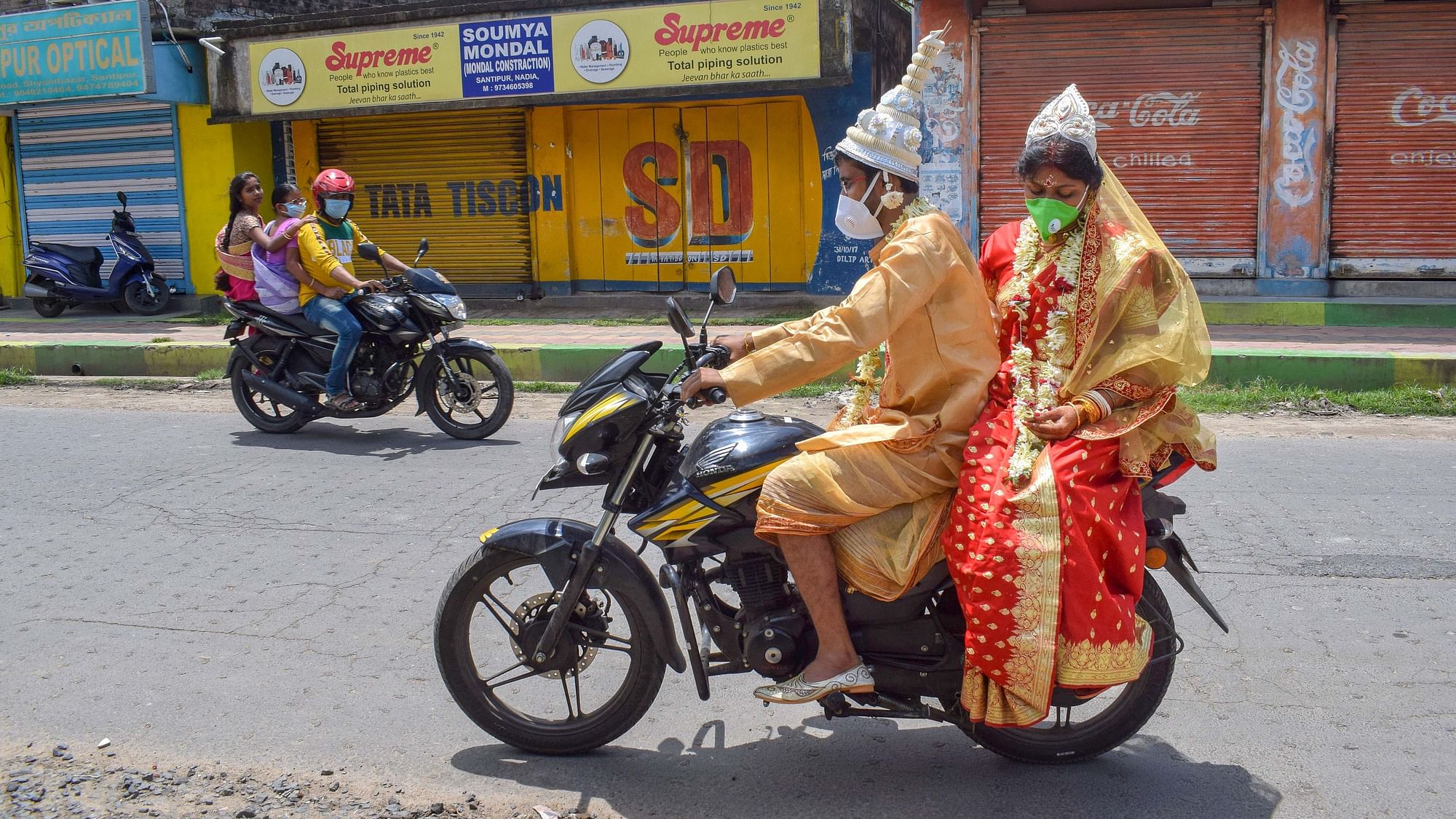 Newly wed couple Soumen Ghosh and Sarmistha ride a motorcycle to return home after their marriage amid COVID-19 pandemic, in Nadia. Image used for representation.