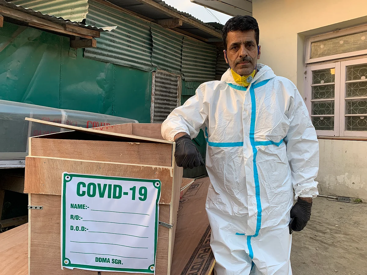 Driver Jameel Ahmed waiting on Tuesday, 28 July, for the body of a COVID-19 casualty outside the mortuary of SMHS hospital in Srinagar.
