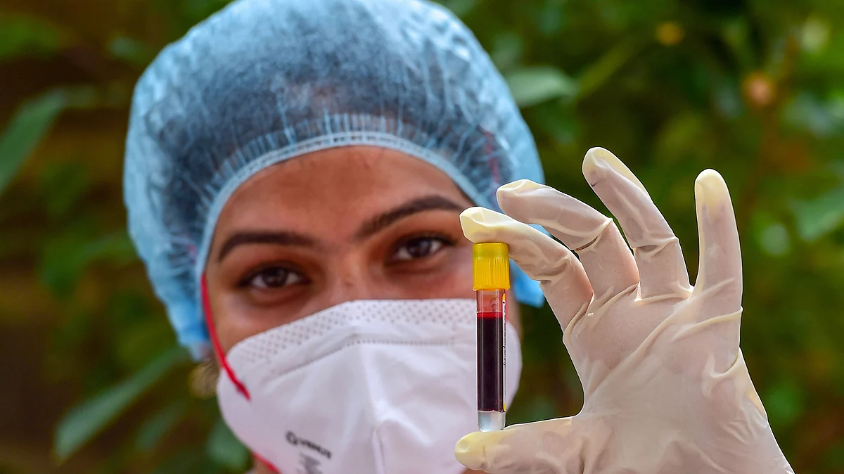 A health worker holds a blood sample, collected for COVID-19 antibody test, during Unlock 4, in New Delhi, Saturday, 5 September, 2020. 