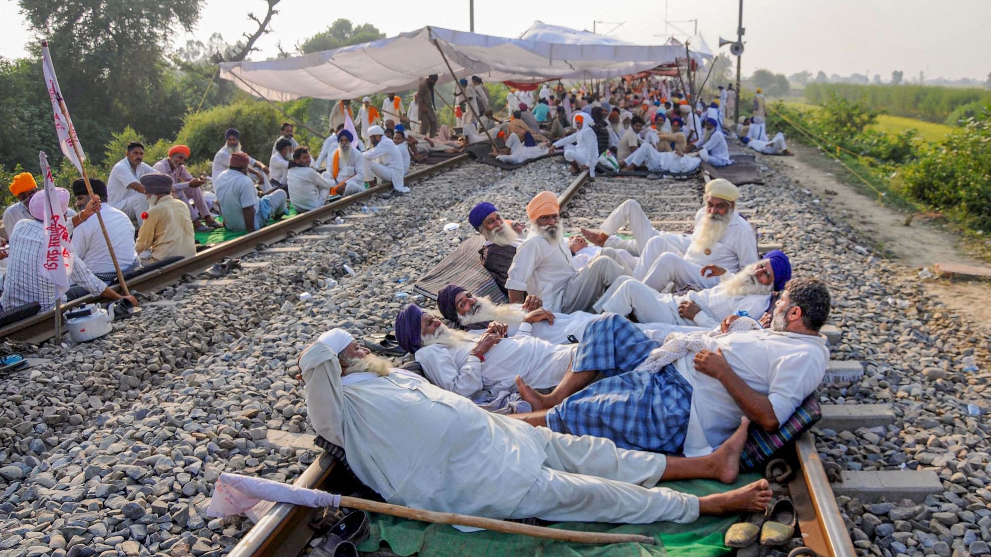 Farmers block a railway track during their protest against the new farm bills, at Devi Dass Pura village, about 20 kilometers from Amritsar, Friday, 25 September.