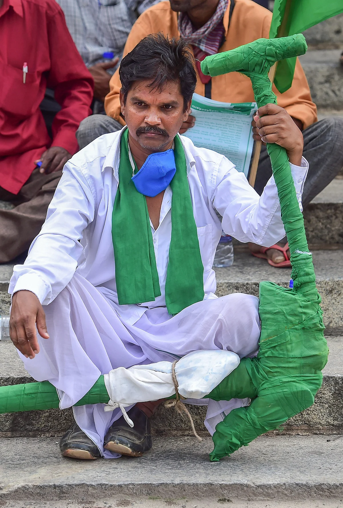 A participant carries a model of a plough during a protest against the farm reform bills passed in Parliament recently, in Bengaluru, Monday, 28 September, 2020.